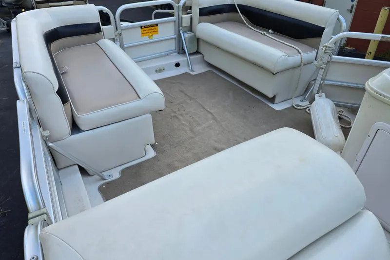 Slide: The Image of 2003 Hurricane 226R boat interior with beige and white seating. - 17