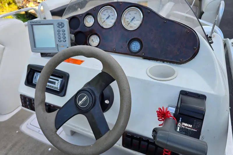 Slide: The Image of Steering console of a 2003 Hurricane 226R boat with gauges and controls. - 18