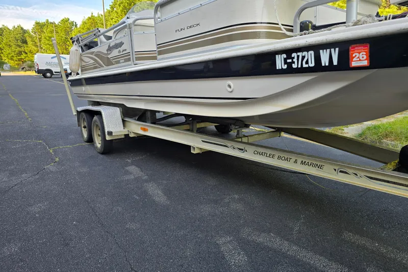 Slide: The Image of 2003 Hurricane 226R Fun Deck boat on trailer in parking lot. - 20