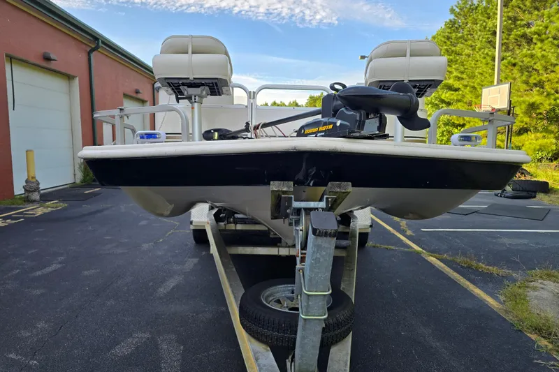 Slide: The Image of 2003 Hurricane 226R boat on trailer, parked outdoors near a building. - 9