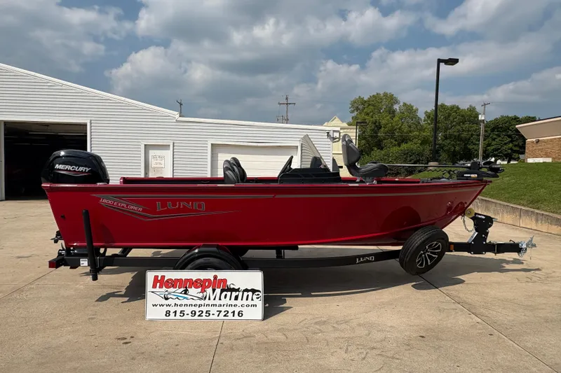 The Image of 2026 Lund 1800 Explorer SS boat in red, parked on a trailer at Hennepin Marine. - 1
