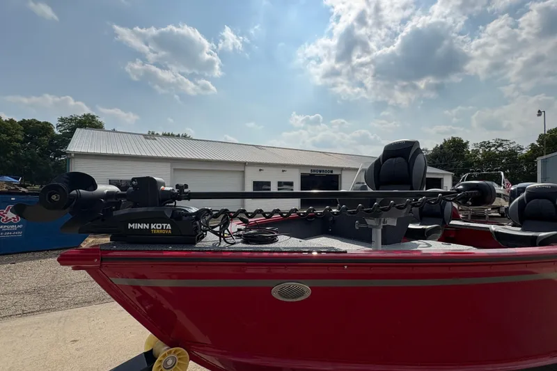 Slide: The Image of 2026 Lund 1800 Explorer SS boat with Minn Kota Terrova motor, parked outside showroom. - 10