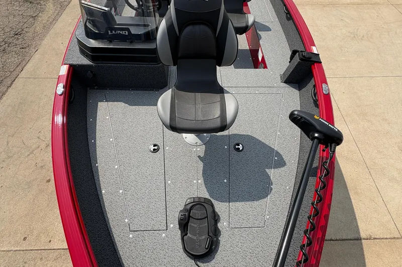 Slide: The Image of 2026 Lund 1800 Explorer SS boat interior with seating and trolling motor. - 11