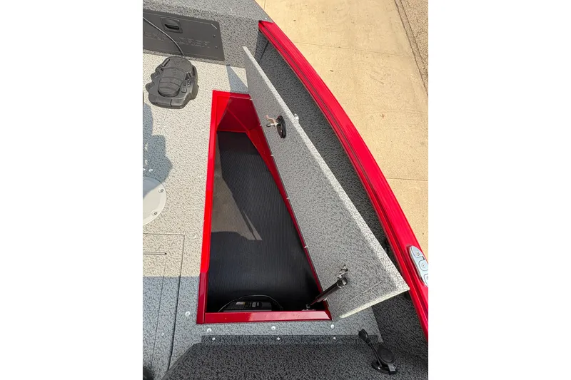 Slide: The Image of 2026 Lund 1800 Explorer SS boat with open storage compartment, featuring red trim and gray interior. - 12