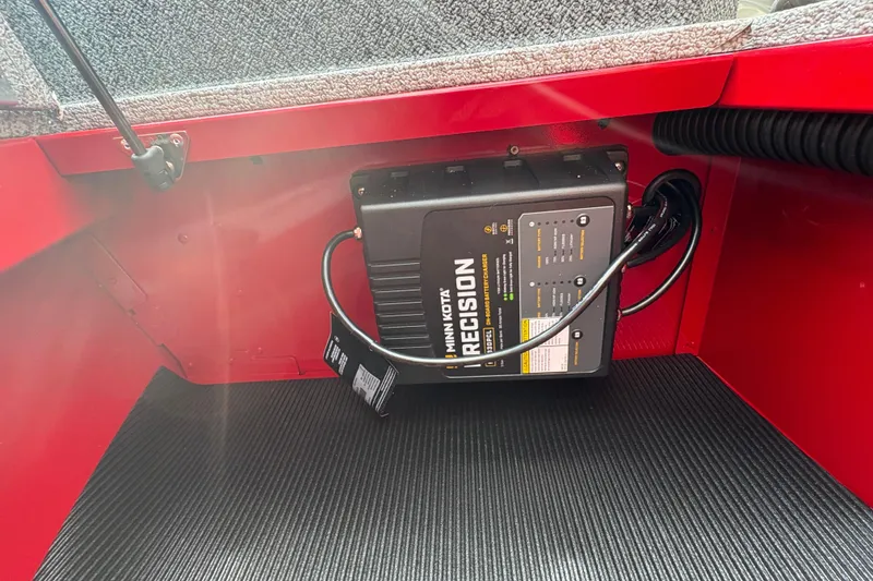 Slide: The Image of Battery charger in 2026 Lund 1800 Explorer SS boat, red interior. - 13
