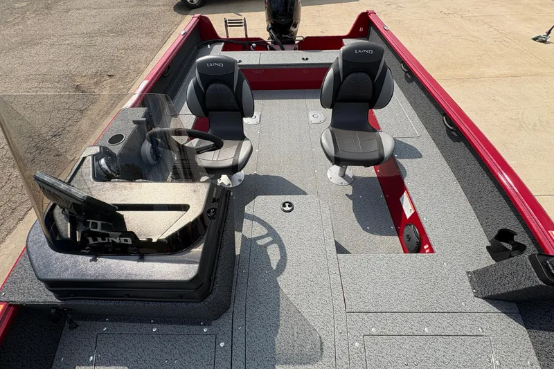 Slide: The Image of 2026 Lund 1800 Explorer SS boat interior with dual seats and steering console. - 16