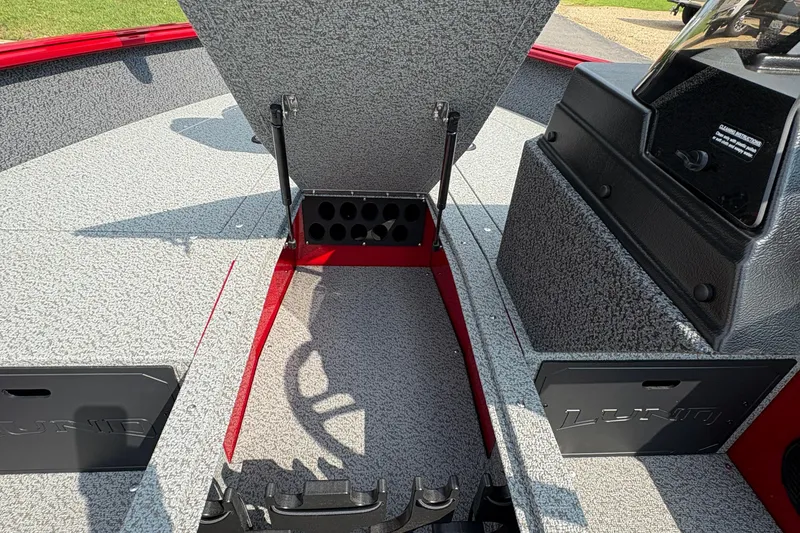 Slide: The Image of 2026 Lund 1800 Explorer SS boat interior with open storage compartment and textured flooring. - 17