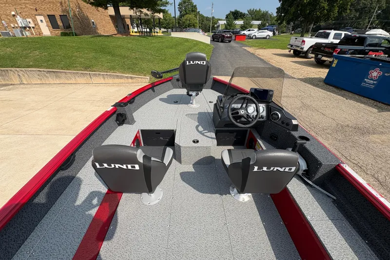 Slide: The Image of 2026 Lund 1800 Explorer SS boat interior with steering console and seating. - 18