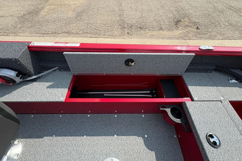 Slide: The Image of 2026 Lund 1800 Explorer SS boat interior with storage compartment and cup holder. - 30