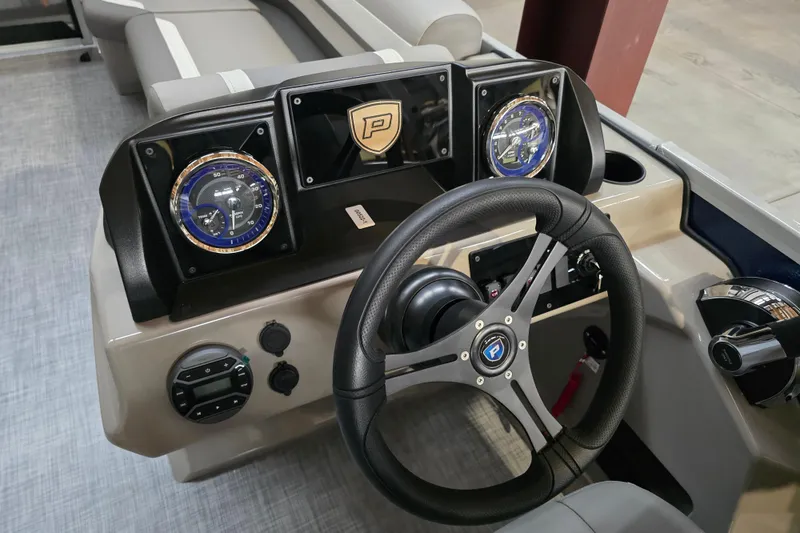 Slide: The Image of Steering wheel and dashboard of 2026 Premier 200 Sunscape boat, featuring modern gauges. - 12