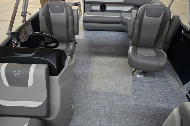 Slide: The Image of Interior of 2025 Premier 200 Sunscape boat with modern gray seating and steering console. - 18