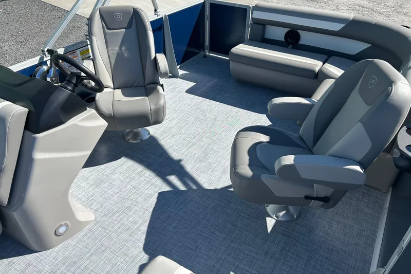 Slide: The Image of 2026 Premier 200 Sunscape boat interior with gray seating and steering console. - 19