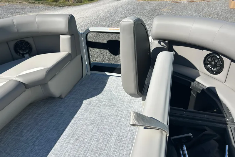 Slide: The Image of 2026 Premier 200 Sunscape boat interior with gray seating and storage compartments. - 25