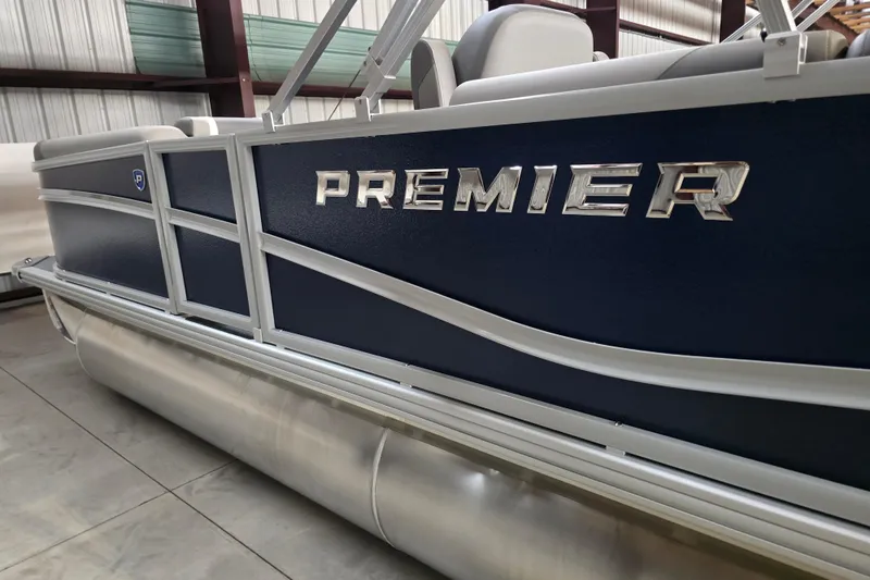 Slide: The Image of 2026 Premier 200 Sunscape pontoon boat with canopy, parked outdoors on gravel. - 5
