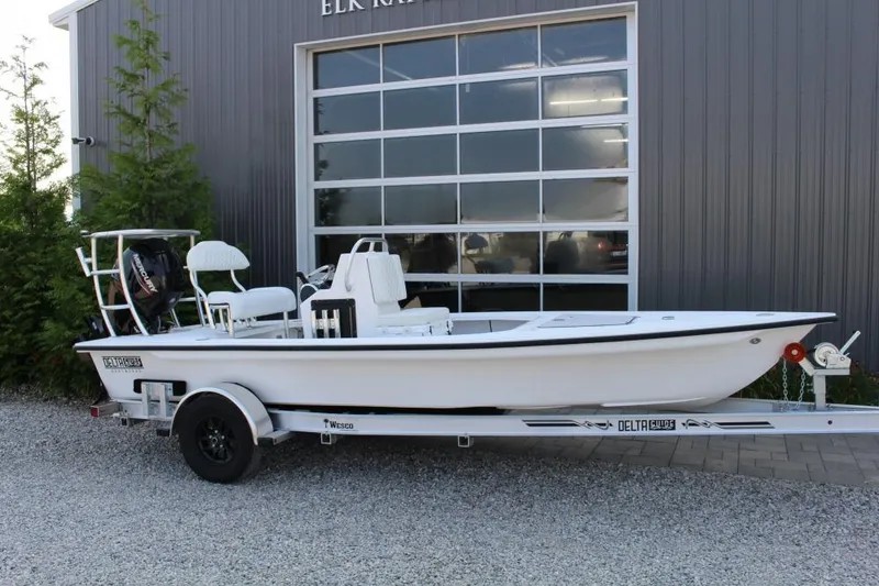 The Image of 2026 Delta D18 boat on trailer outside a building, ready for transport. - 1