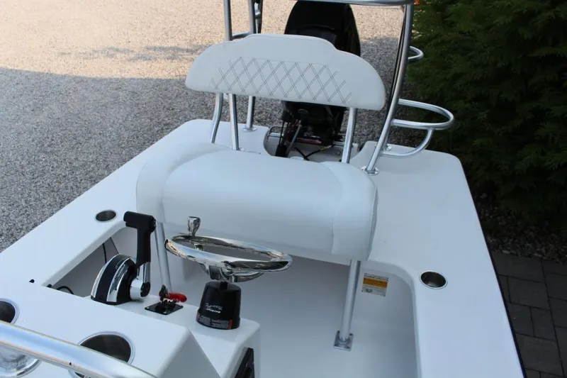 Slide: The Image of 2026 Delta D18 boat interior with white seating and control panel. - 10