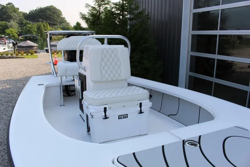 Slide: The Image of 2026 Delta D18 boat with white seating and Yeti cooler on deck. - 4