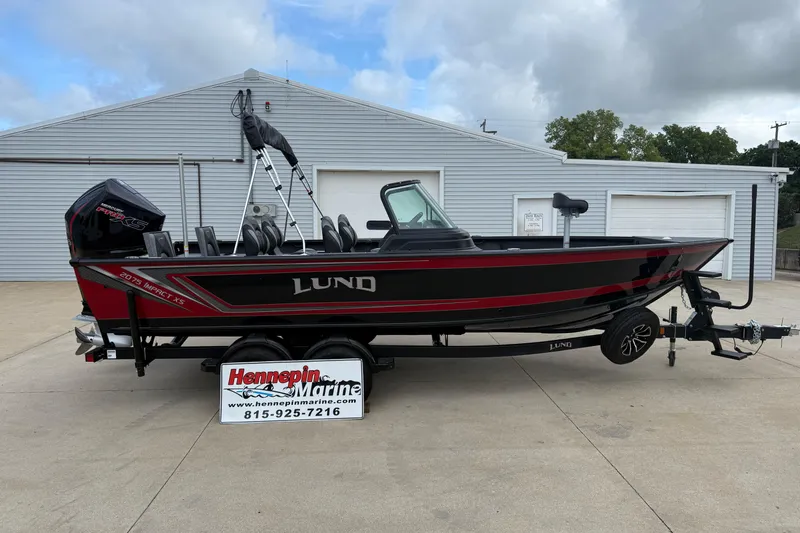 The Image of 2026 Lund 2075 Impact XS boat on trailer, displayed at Hennepin Marine dealership. - 0