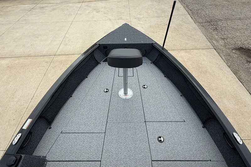 Slide: The Image of 2026 Lund 2075 Impact XS boat deck with seating, shown on a concrete surface. - 10