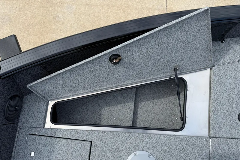 Slide: The Image of 2026 Lund 2075 Impact XS boat storage compartment with open hatch, showcasing interior design. - 12