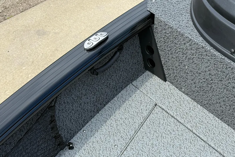 Slide: The Image of Interior view of 2026 Lund 2075 Impact XS boat, featuring textured flooring and side panel details. - 13