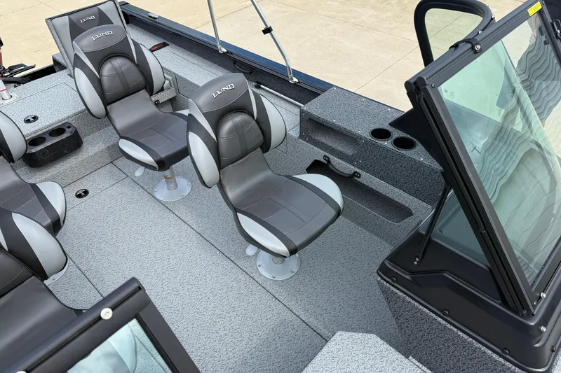Slide: The Image of 2026 Lund 2075 Impact XS boat interior with gray seating and windshield. - 17