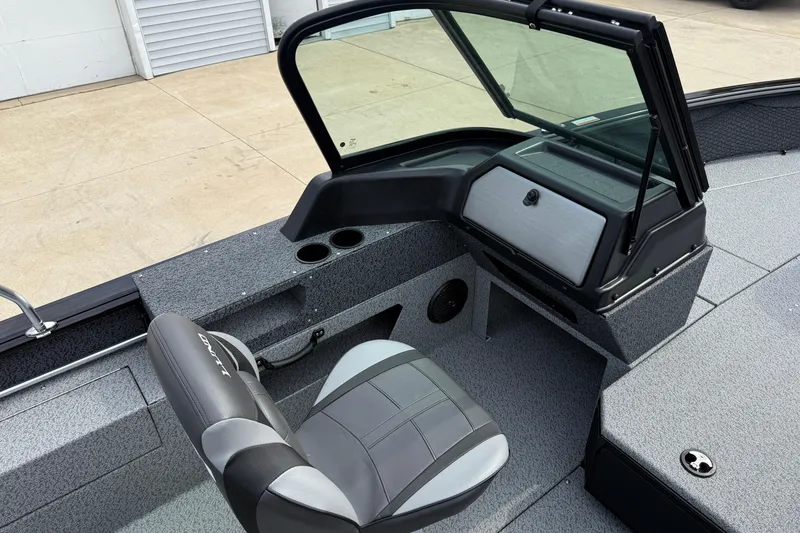 Slide: The Image of 2026 Lund 2075 Impact XS boat interior with seating and console, featuring modern design elements. - 20