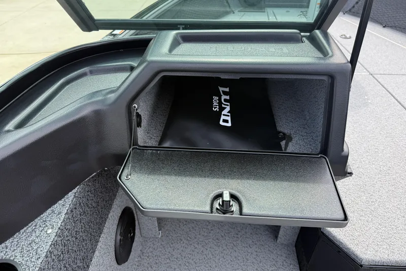 Slide: The Image of 2026 Lund 2075 Impact XS boat storage compartment with open hatch and visible interior. - 21