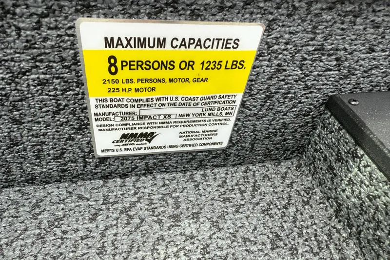 Slide: The Image of 2026 Lund 2075 Impact XS capacity label, 8 persons or 1235 lbs, 225 HP motor. - 22