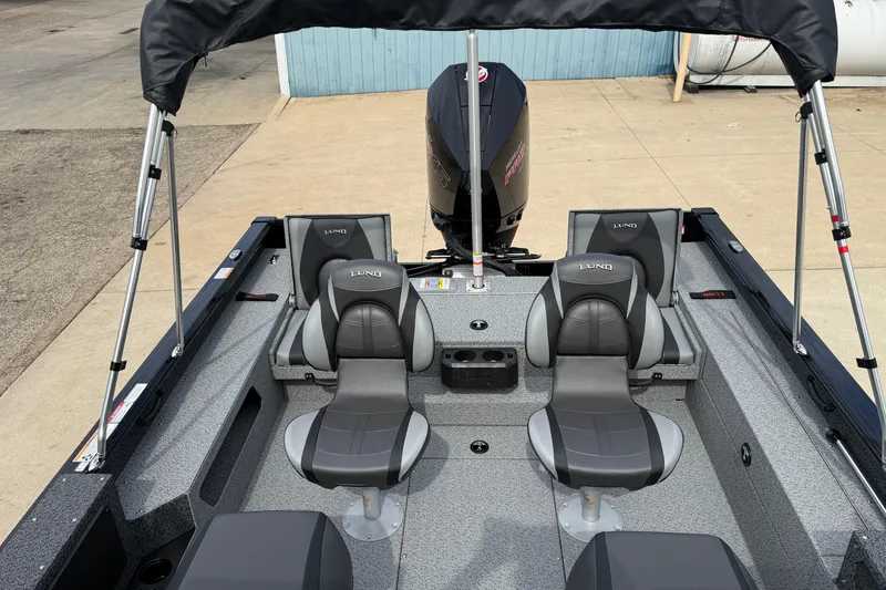 Slide: The Image of 2026 Lund 2075 Impact XS boat interior with seating and motor, showcasing modern design. - 23