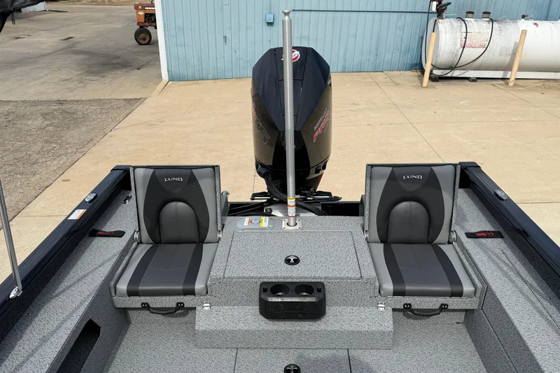 Slide: The Image of 2026 Lund 2075 Impact XS boat interior with two seats and motor. - 25