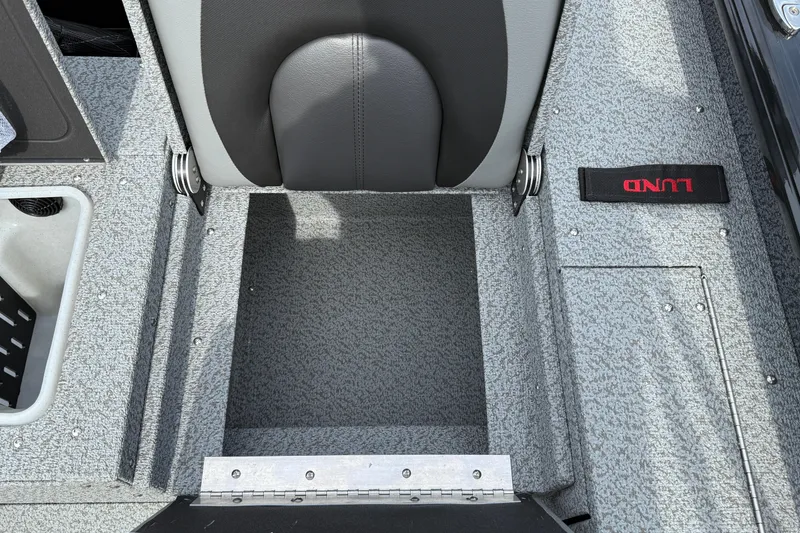 Slide: The Image of 2026 Lund 2075 Impact XS boat interior with gray seating and flooring. - 27