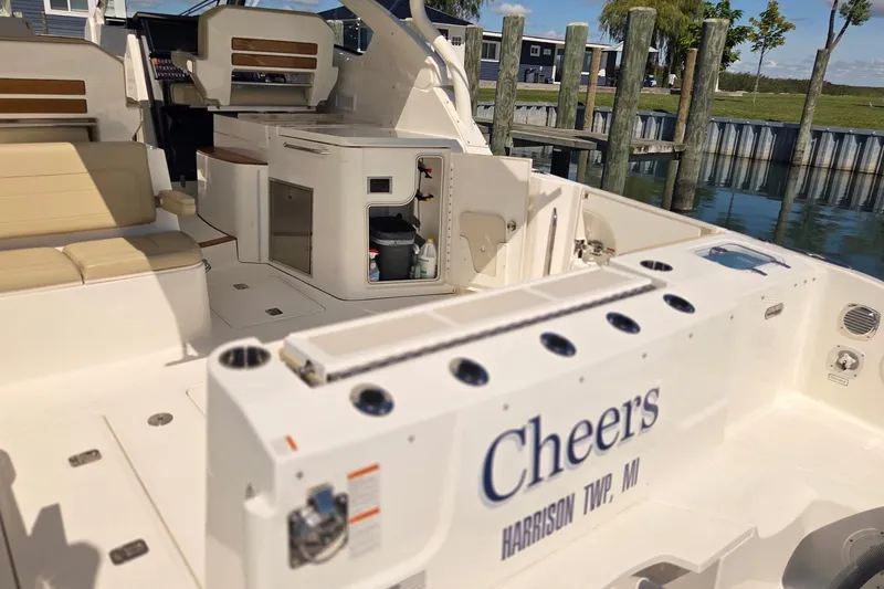 Slide: The Image of 2020 Pursuit DC 365 Dual Console boat interior with seating and storage, docked in Harrison Township, MI. - 14