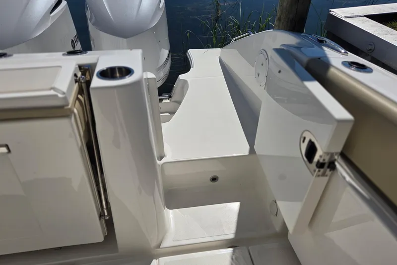 Slide: The Image of 2020 Pursuit DC 365 Dual Console boat interior with seating and storage compartments. - 17