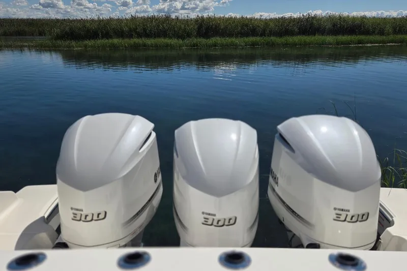 Slide: The Image of Three Yamaha 300 outboard motors on a 2020 Pursuit DC 365 Dual Console boat. - 18