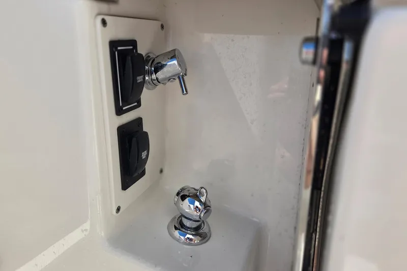 Slide: The Image of Control panel on 2020 Pursuit DC 365 Dual Console boat, featuring switches and chrome fittings. - 20