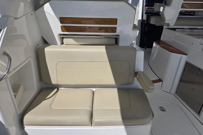 Slide: The Image of 2020 Pursuit DC 365 Dual Console boat interior with beige seating and modern design. - 25