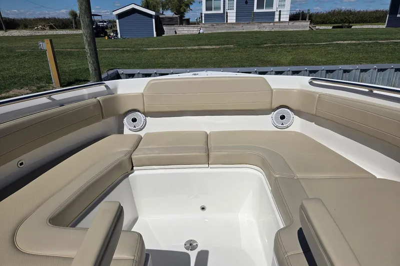 Slide: The Image of 2020 Pursuit DC 365 Dual Console boat interior with beige seating and speakers. - 27