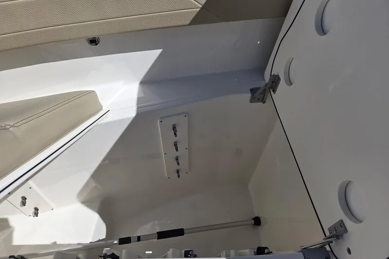 Slide: The Image of 2020 Pursuit DC 365 Dual Console interior storage compartment with beige seating and white finish. - 28