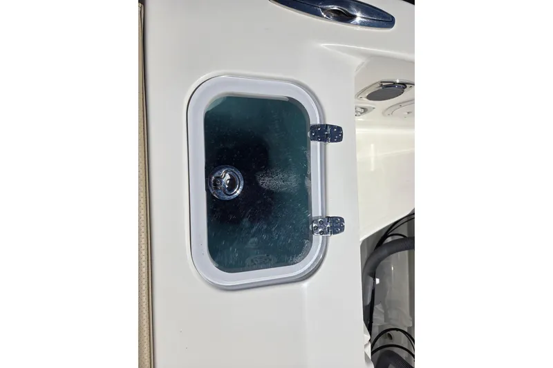 Slide: The Image of 2020 Pursuit DC 365 Dual Console boat compartment with hinged glass cover. - 32