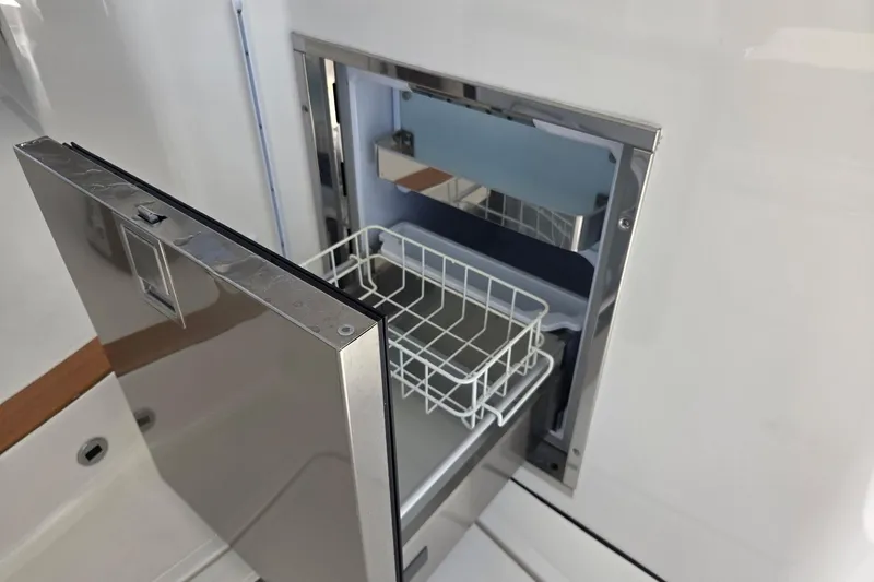 Slide: The Image of Open stainless steel drawer on 2020 Pursuit DC 365 Dual Console boat. - 38