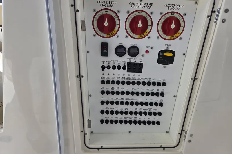 Slide: The Image of Control panel of a 2020 Pursuit DC 365 Dual Console boat, featuring engine and electronics switches. - 40