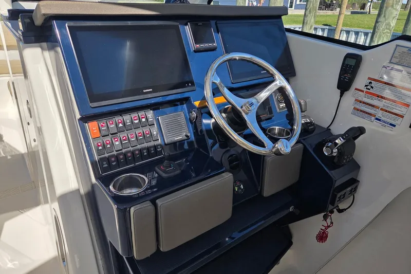 Slide: The Image of 2020 Pursuit DC 365 Dual Console boat helm with modern controls and navigation screens. - 46