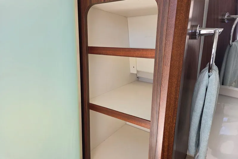 Slide: The Image of 2020 Pursuit DC 365 Dual Console interior shelving with wooden finish and towel rack. - 52