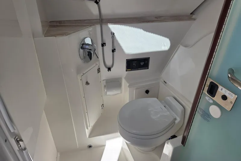 Slide: The Image of 2020 Pursuit DC 365 Dual Console boat bathroom with toilet and shower. - 54