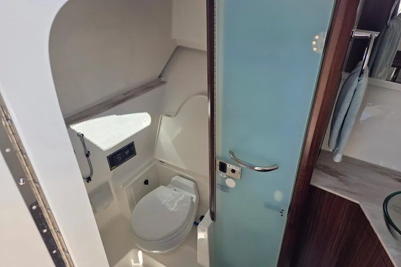 Slide: The Image of 2020 Pursuit DC 365 Dual Console boat bathroom with modern amenities and sleek design. - 55