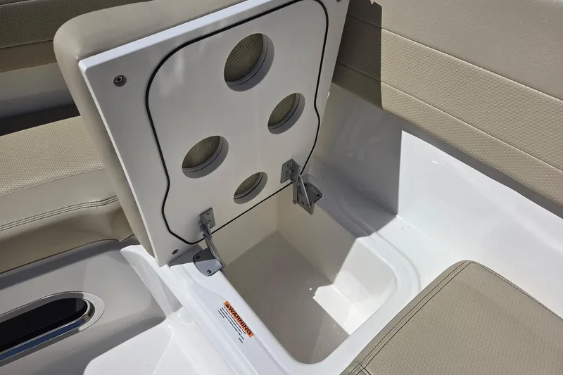 Slide: The Image of 2020 Pursuit DC 365 Dual Console storage compartment with beige seating and white interior. - 59