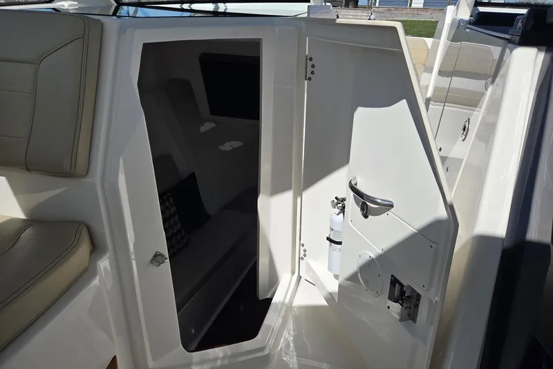 Slide: The Image of 2020 Pursuit DC 365 Dual Console cabin interior with seating and fire extinguisher. - 61