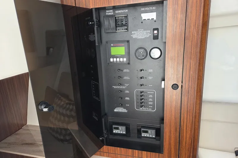 Slide: The Image of Electrical control panel on 2020 Pursuit DC 365 Dual Console boat, featuring various switches and gauges. - 66