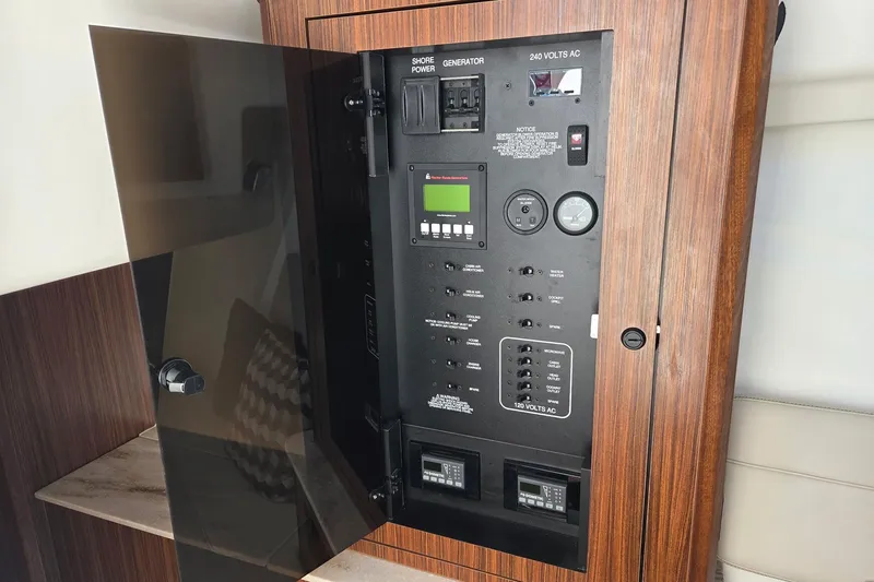 Slide: The Image of Electrical panel of 2020 Pursuit DC 365 Dual Console boat, featuring various controls and switches. - 67